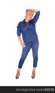 A lovely woman in jeans and jeans jacket standing isolated for white background lifting her hand over her head.