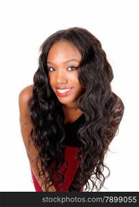 A lovely young African American woman with long curly black hairbending forward, isolated for white background.