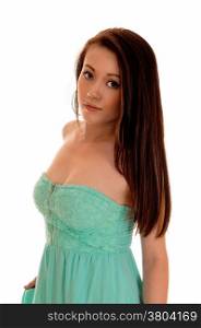 A lovely young Asian woman with long brunette hair wearing a turquoisedress, standing isolated for white background.