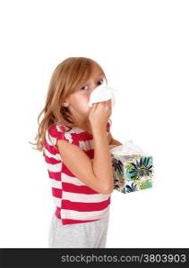 A lovely young blond girl holding a tissue on her running nose,isolated for white background.