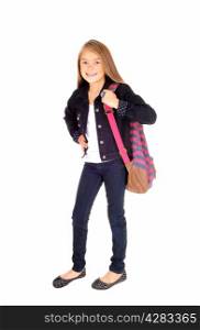 A lovely young blond schoolgirl standing isolated for white backgroundwith her backpack over her shoulder.