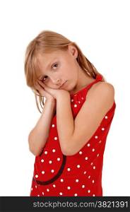 A lovely young girl holding her hands on her face, looking sad, isolatedon white background.