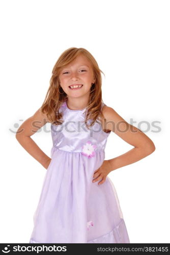 A lovely young girl in a pink dress with her hands on her hips, standingisolated for white background.