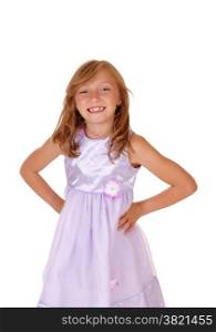 A lovely young girl in a pink dress with her hands on her hips, standingisolated for white background.