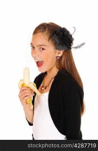 A lovely young girl standing in a closeup picture, isolated for whitebackground, open her mouths and eating the banana.