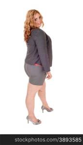 A lovely young plus size woman standing isolated for white backgroundin a gray jacket and shorts.