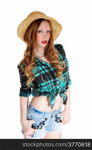 A lovely young teen girl in shorts and blouse with a straw hat standingisolated for white background.