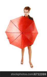 A lovely young woman in a black dress and brown leather jacket and highheels standing white background holding an red umbrella in frond of her.