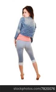 A lovely young woman standing from the back for white background, inblue thighs, pink t-shirt and jeans jacket, looking over her shoulder.