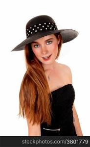 A lovely young woman with long brunette hair and a black hat standingisolated for white background.