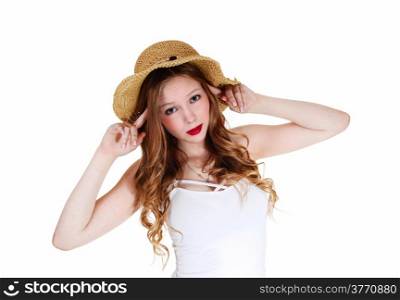 A lovely young woman with long curly blond hair wearing a beige strawhat, isolated for white background.