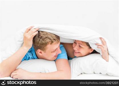 a loving couple was covered with a blanket