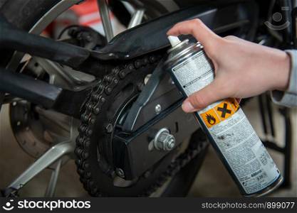 a lubricating motorcycle chain with chain spray grease