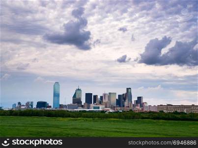 A lush green beltway appears in front of the urban landscape of Houston, TX USA