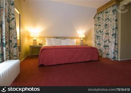 A luxury double bed in a warm, cosy bedroom