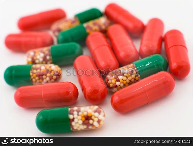 a macro shot of medicines, red and green capsules