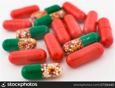 a macro shot of medicines, red and green capsules
