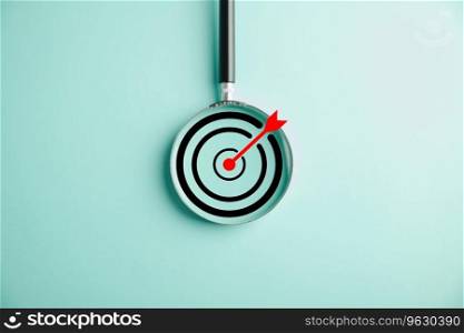 A magnifier glass zooms in on a target board, depicting the business objective, target search concept, and success. Isolated on a background with copy space.