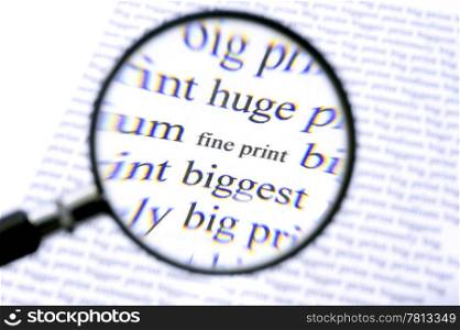 A magnifying glass, zooming in on the text Fine Print on a sheet of paper, surrounded by bigger letters. The chromatic aberation of the cheap magnifying glass with its plastic lense is intentional.