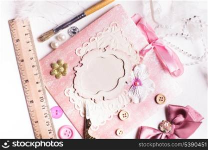A making scrapbooking postcard with tolls and decorations on the table
