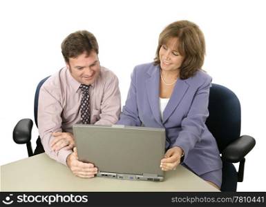 A male and female business colleague working on a project together using a laptop. Or a professional showing something on the computer to a client.
