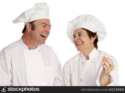 A male and female chef laughing together. Isolated on white.