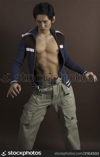 A male asian model in casual clothes exposes his torso