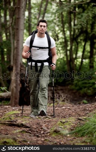 A male backpacking in the forest on a camping trip