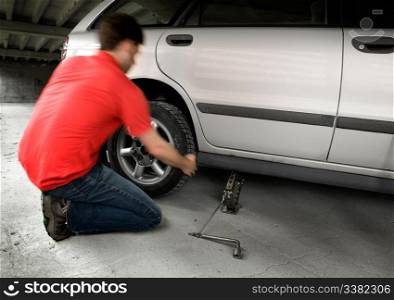 A male changing a tire quickly