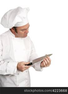 A male chef testing the sharpness of his knife blade. Isolated on white with room for text.