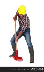 A male construction worker using a shovel.