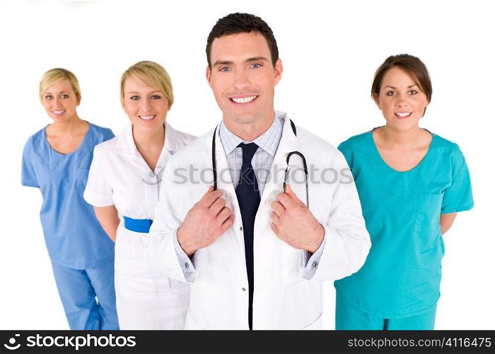 A male doctor with his team of colleagues out of focus behind him.