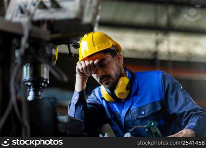 A male engineer or worker is stressed at work. heavy industrial plant concept