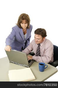 A male-female business team working intensely trying to meet a deadline. Isolated on white.