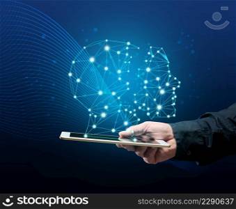 a male hand holds a tablet and a holographic drawing of a robot head. The concept of learning artificial intelligence to improve search engines, application performance and satisfaction of needs