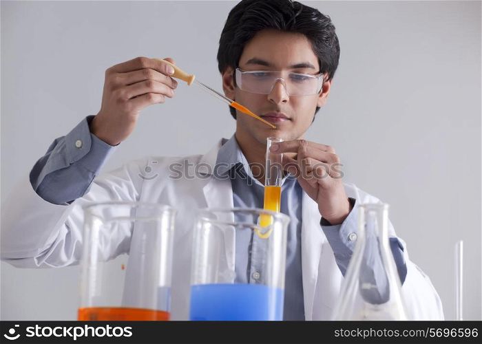 A male researcher at work using a pipette