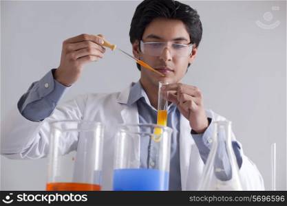 A male researcher at work using a pipette