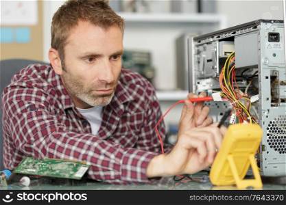 a male technician fixing computer