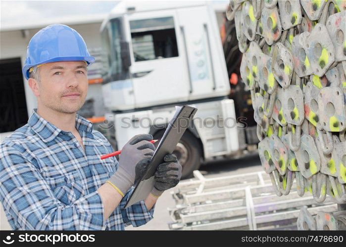 a male worker with clipboard