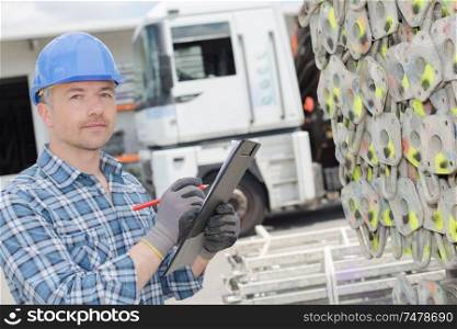 a male worker with clipboard