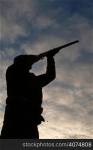 A man aiming his gun