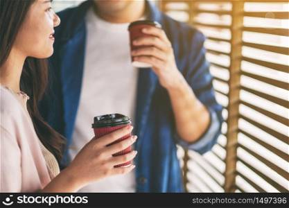 A man and a woman drinking coffee together