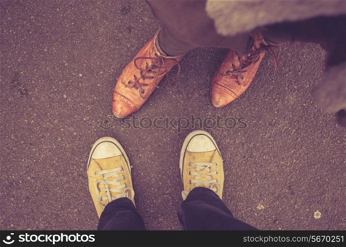 A man and a woman&rsquo;s feet as they&rsquo;re standing opposite each other