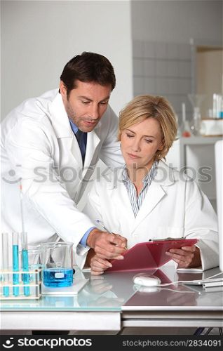 A man and a woman working in a lab.