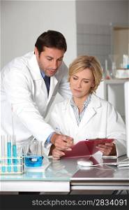 A man and a woman working in a lab.