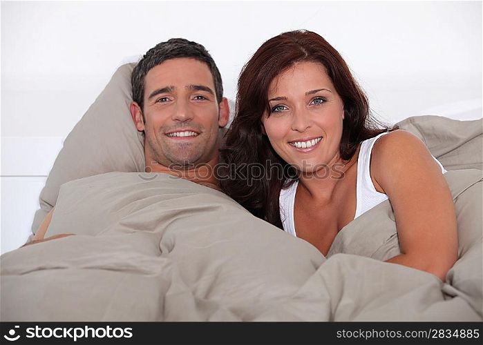 A man and woman lying in bed