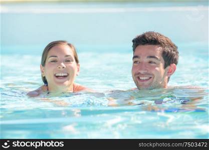 a man and woman swimming