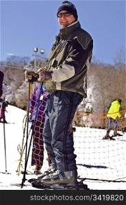A man at a ski resort ready to hit the slopes.