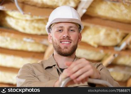 a man builder is smiling indoors