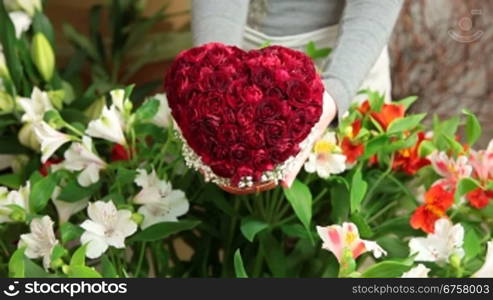 A man buying Valentines Day rose heart bouquet in florist shop
